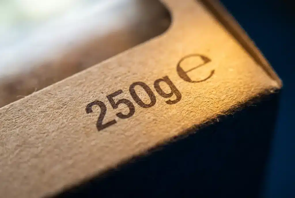 A packaged product's label showing its nominal weight and the voluntary e-mark used under UK average weight legislation